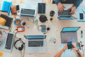 Top view of laptop, coffee cup, and CRM software tools on desk